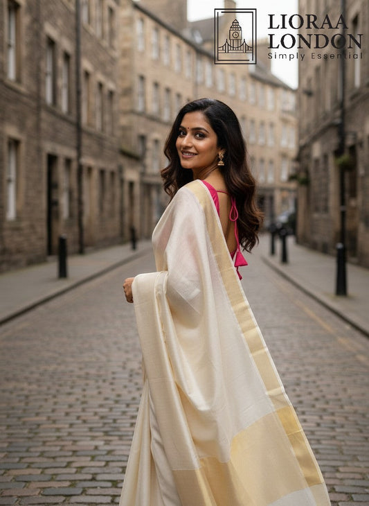 Lioraa London Ltd gajri cotton silk blouse with sweetheart neckline worn with a cream saree on a city street.