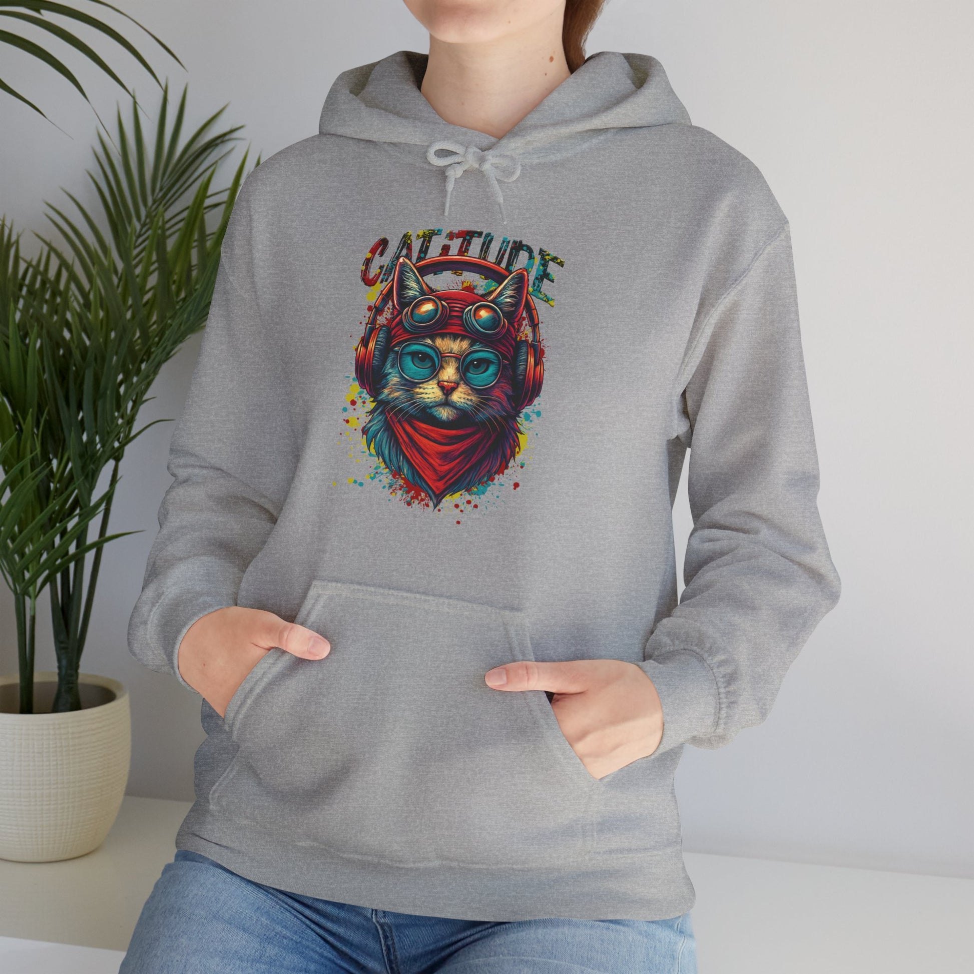 Person wearing a gray hoodie with a colorful cat design and 'Catitude' text.