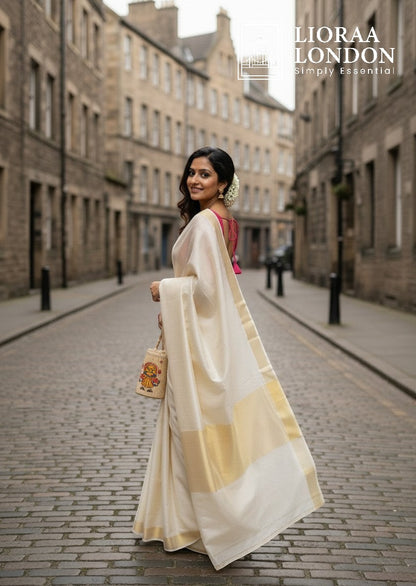 Lioraa London Ltd gajri silk blouse worn by a woman in a cream saree with gold border on a cobblestone street