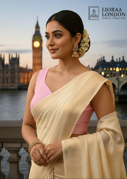 Lioraa London Ltd peach pink silk blouse with sweetheart neckline worn with a cream saree against a London backdrop.